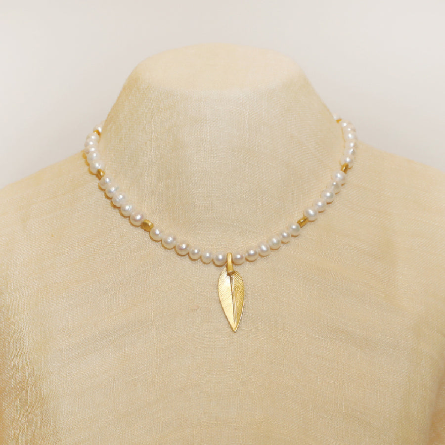 beautiful real pearls necklace with a golden feather pendant 